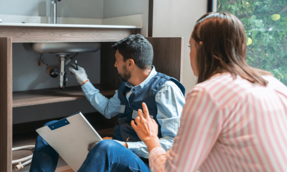 5 Critical Insurance Coverages Contractors Often Overlook - Worker checking the pipes under the sink